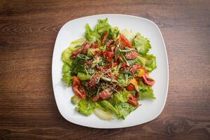 gastrónomo mezclado ensalada con ahumado Pato mama, Cereza Tomates, naranja y pino nueces, sazonado con agrios vendaje foto