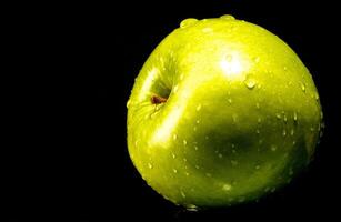 Green apple with water droplets photo