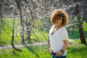 Fashion shot of a beautiful boho style girl on nature background. Boho, hippie. photo