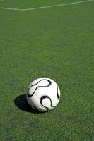 football or soccer ball on the grass photo