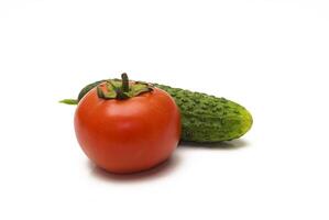 Tomatoes and cucumbers on a white background photo