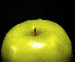 Green apple with water droplets photo