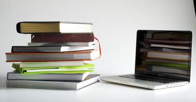 Stack of book and laptop photo