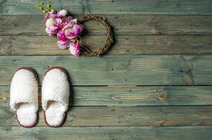 White slippers on the wooden background. Beauty and fashion. photo