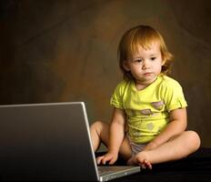 pequeño niña trabajos con el computadora foto