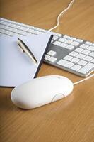 Modern aluminum computer keyboards, mouse and notebook photo