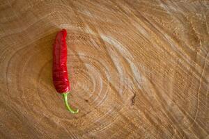 Red chilli pepper on a wooden background photo