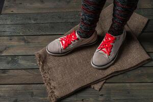 Legs in color socks on a wooden floor photo