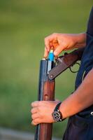 Silhouette of people with guns at sunset photo