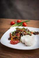 Spicy beef with vegetables and rice. Asian style food photo