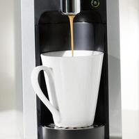 A coffe machine is brewing some coffee. photo