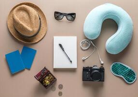 Packed suitcase of vacation items on wooden table, top view photo