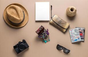 Packed suitcase of vacation items on wooden table, top view photo