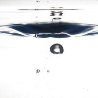 The round transparent drop of water, falls downwards photo