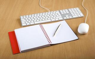 Modern aluminum computer keyboards, mouse and notebook photo