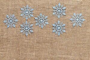 Snowflakes on textile background. Winter holidays concept photo