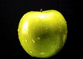 Green apple with water droplets photo