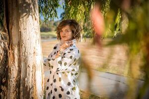 Fashion shot of a beautiful boho style girl on nature background. Boho, hippie. photo