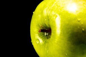 Green apple with water droplets photo