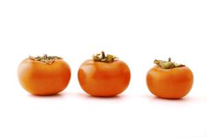 Ripe persimmon on the white background photo