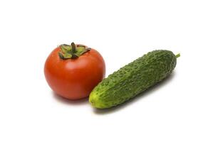 Tomatoes and cucumbers on a white background photo