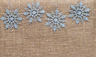 Snowflakes on textile background. Winter holidays concept photo