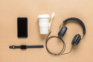 Business concept. Top view of earphones, watch, smartphone on color background photo