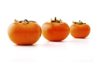 Ripe persimmon on the white background photo