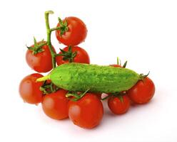Ripe tomatoes on a branch and cucumber on a white background photo