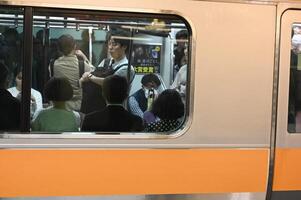 Tokyo Japan may 15 2023  A Glimpse into Tokyo's Commuting Culture Silent Conversations Amidst the Metro's Rush Hour photo