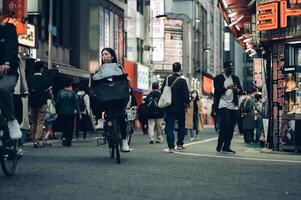 Shinjuku, Tokyo May 05 2023 Nighttime Hustle and Bustle in Shinjuku A Vibrant Encounter of Neon Lights, Izakaya, and Crowded Streets photo