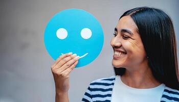 Woman holding blue paper cut happy smile face, positive, customer review, Compliment Day, mental health assessment,Compliment Day, world mental health day concept, satisfaction concept, AI Generative photo