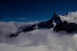 the mountain range of mont blanc covered with snow at punta hellbronner in courmayeur in the aosta valley in july 2023 photo