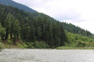 Scenic view of the natural beauty of Tao Butt, Neelum Valley, Kashmir.  Tao Butt is famous for its lush green trees and natural beauty. photo