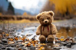 Lonely Teddy bear doll standing alone with blurry autumn forest background,Lost brown bear toy looking sad,International missing children's day,Generative Ai photo