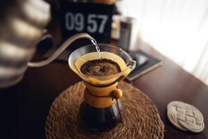 Drip coffee,Pouring water into filter coffee maker photo