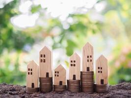 Miniature house on stack of coins. The concept of Property investment, House mortgage, Real estste. photo