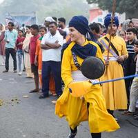 Delhi, India, October 2, 2023 - Sikhs display gatka and martial arts during annual Nagar Kirtan, Traditional, procession on account of birthday of Guru Nanak Dev ji, Nagar Kirtan in East Delhi area photo