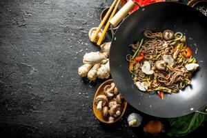 Prepared Chinese noodles wok soba with ignredients for its preparation. photo