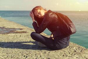 beautiful woman in jeans and jacket. Sea photo