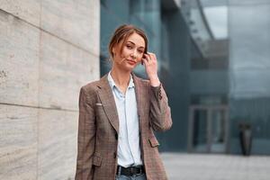 Businesswoman successful woman business person standing outdoor corporate building exterior. Pensiv caucasian confidence professional business woman middle age photo