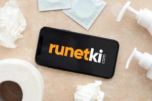 KYIV, UKRAINE - JANUARY 23, 2024 Runetki adult content website logo on display of iPhone 12 Pro photo