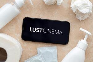 KYIV, UKRAINE - JANUARY 23, 2024 LustCinema adult content website logo on display of iPhone 12 Pro photo