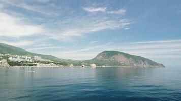 Gurzuf resort city panoramic view on Bear Mountain, Ayu-Dag, Yalta, Crimea. Spring sunny day. Nature summer ocean sea beach background. Vacation, travel and holiday concept. video