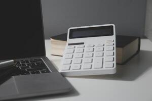 Flat lay, top view office table desk. Workspace with calculator,pen,laptop on white background.Copy Space for text,Empty Blank to word.Business Finance,Education Technology.Work from home. photo