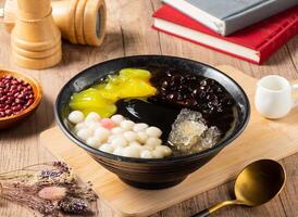 Taiwan sweet mango, soybean, jelly, tofu and black and white served in bowl isolated on table top view of asian food photo