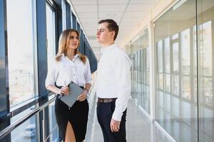 Work in office. Kind man holding laptop while looking at his partner photo