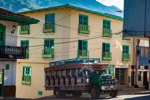 Colorful traditional rural bus from Colombia called chiva at the central square of the small town of Pacora in Colombia photo