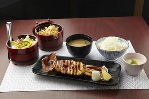 Akimitsu - Ika Rice Set served in a dish isolated on wooden table side view of singapore food photo