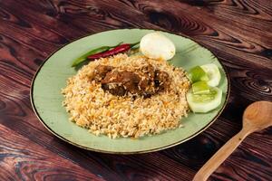 spicy beef pulao, polao, biryani, mandi, kacchi with egg and salad served in dish isolated on table top view of indian food photo